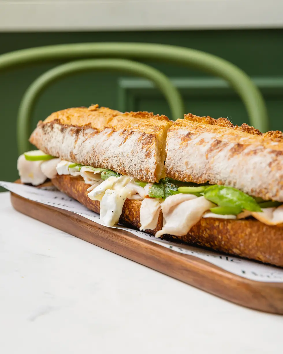 Turkey brie baguette sandwich with greens and cheese at Café Bastille, a classic choice for gourmet brunch sandwiches Miami