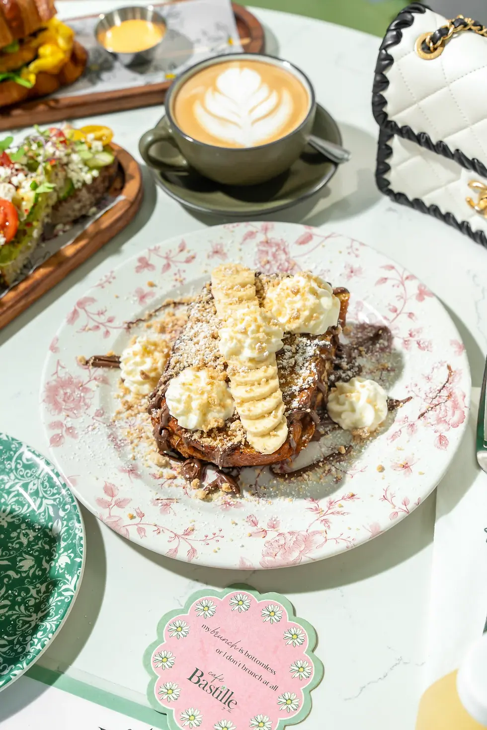 French Toast stuffed with Nutella, topped with fresh bananas, cookie crumble, and butter whipped cream for the best brunch in Miami.