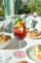 Glass of sangria with fruit and mint served alongside waffles and croissants, perfect for best brunch Miami