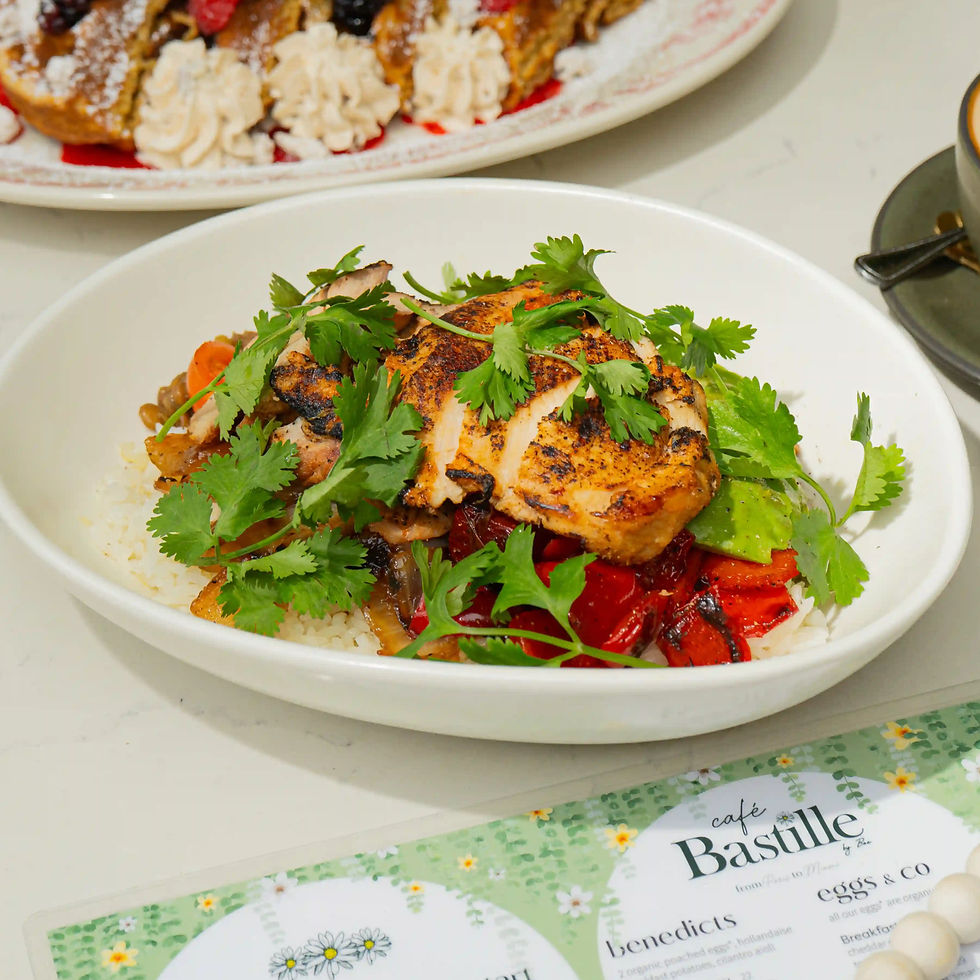 Stella's Fav Bowl with sliced grilled chicken thighs over rice, red peppers, onions, and abundant cilantro in a white bowl
