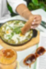 Green shakshuka with eggs, spinach, feta, and jalapeños at Cafe Bastille.