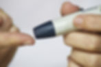 person testing finger for autoimmune disease Type 1 diabetes