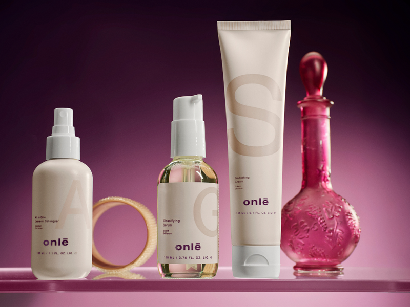 onlē professional haircare product lineup on a glass shelf