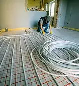 man-laying-underfloor-heating-in-a-house.webp