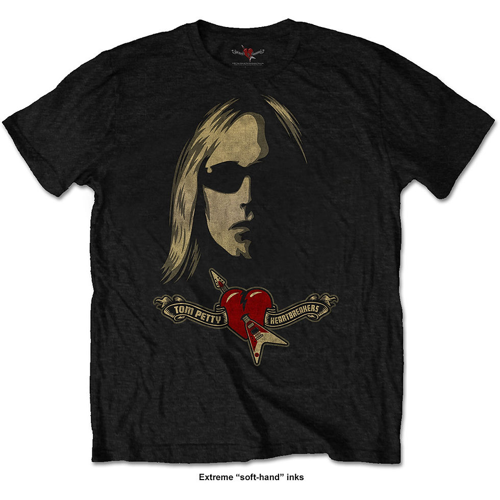 Black t-shirt with red heart pierced by guitar and “Tom Petty & The Heartbreakers” banners; unisex short-sleeve fit.