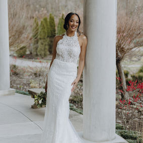 Sheer romance comes to life in Style D4120, a sexy lace halter neck wedding gown designed with the modern bride in mind. A high halter neckline wraps around the neck, forming an eye-catching graphic lace bodice and open back detail that reveals the corset structure underneath. A discreet row of fabric-covered buttons line the centre back to resolve at the hip where modest ruching and expertly-placed lace appliques flatter the form and accentuate the natural curves of the body. Past the hip, this romantic fit-and-flare bridal gown flares into a soft tulle sweeping train scattered and shaped by floral lace accents for a final enchanting detail.