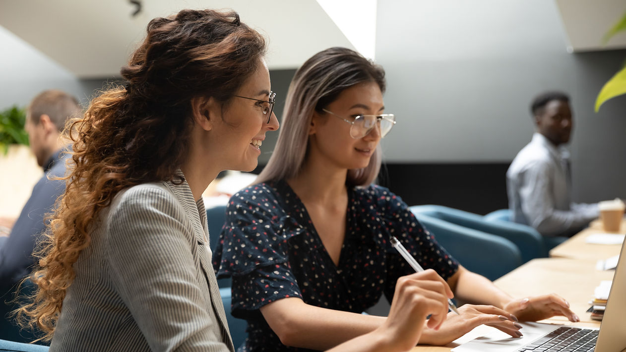 two women working on a computer .jpeg