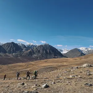 Four trekkers in Mongolia with the Altai mountains in the background.