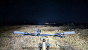 Behind the handlebars of a mountain bike at night
