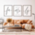 Cozy living room scene featuring a comfortable couch paired with a coffee table, adorned with three framed pictures