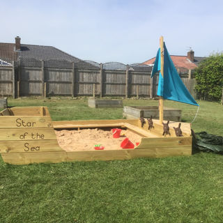 Reception enjoying our beautiful new sand pit in the sunshine!