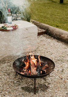 Outdoor firepit with ember glow at Contained in Nimbin Nightcap Cabin.
