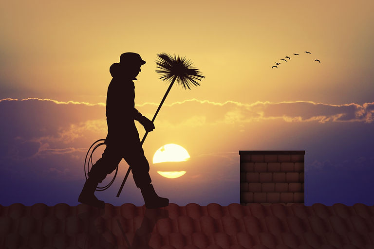 chimney sweep on roof with sunset