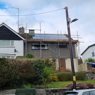 Residential house on the street. Roofing South West with a car parked nearby.