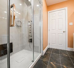 clear-glass-bathroom-and-closed-white-wo