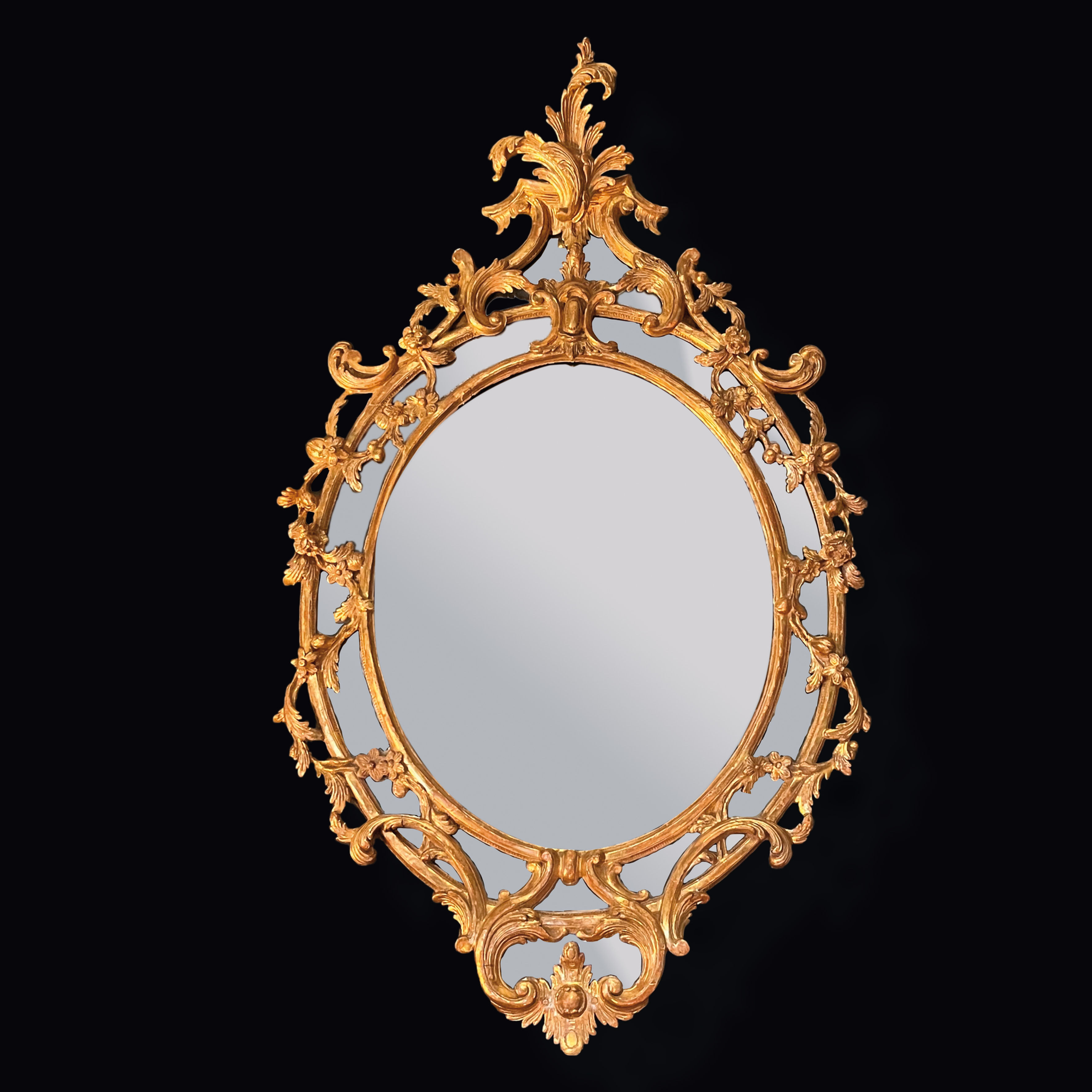 Antique Chippendale period oval carved wood and gilded mirror