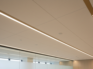 Eye-level view of a modern office ceiling with integrated seamless linear lighting