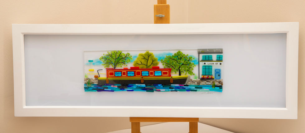 Presenting "Canal Boat at Lock 17," an exceptional fused glass picture by the distinguished artist Greig Black, exclusively available at BlackNoir Glass. This remarkable artwork features a canal boat docked beside one of the lock houses. Each glass piece is meticulously hand-cut and shaped, demonstrating the superior craftsmanship synonymous with our unique, handmade glass gifts. Ideal for enhancing your space with artistic flair or as a bespoke gift, this intricate work highlights our dedication to quality and creativity. Visit our website to discover more personalized, made-to-order glass artworks tailored to your individual taste.
Measuring 30cm x 9cm for the glass panels and framed at 60cm x 20cm.
Cost: £210.00