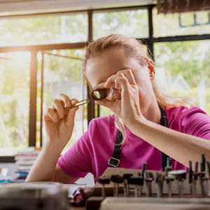 Appraiser examining an object closely, representing how buyers assess business value