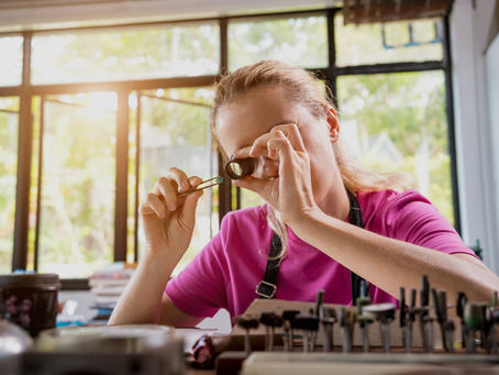 Appraiser examining an object closely, representing how buyers assess business value