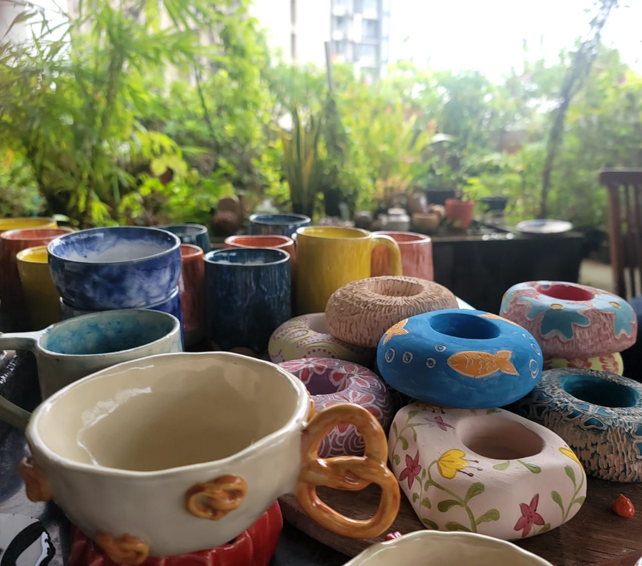 Beginner shaping a bowl by hand in a cozy pottery studio during a one-day handbuilding session.