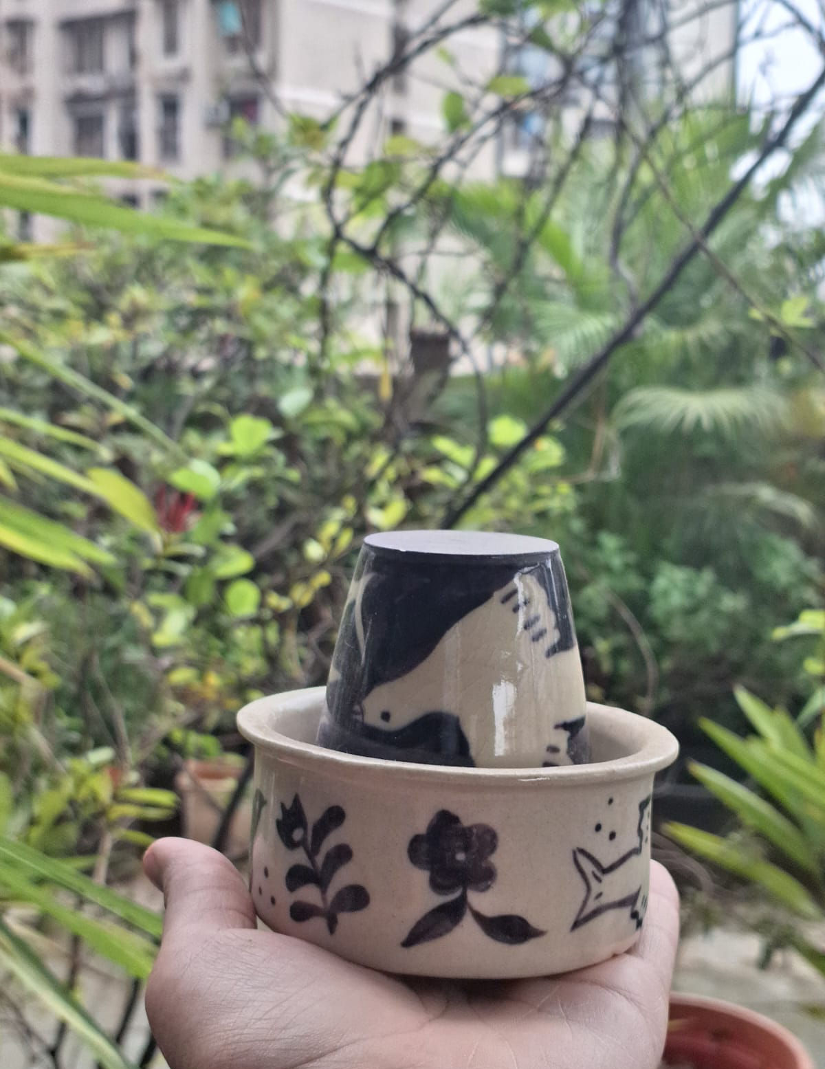 Colorful ceramic pieces being painted with underglaze by participants in a pottery painting workshop