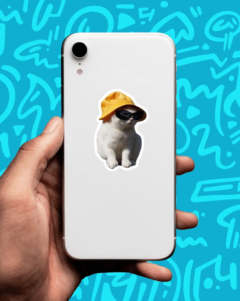 cat with a yellow hat sticker pasted on back of a mobile phone and it has a blue background