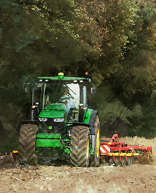 Green tractor works the field