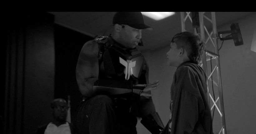 TMoore The Motivator speaking one-on-one with a student during a school assembly Q&A
