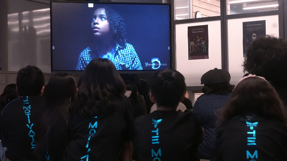 Students engaged in storytelling video showcasing speaker’s journey and resilience