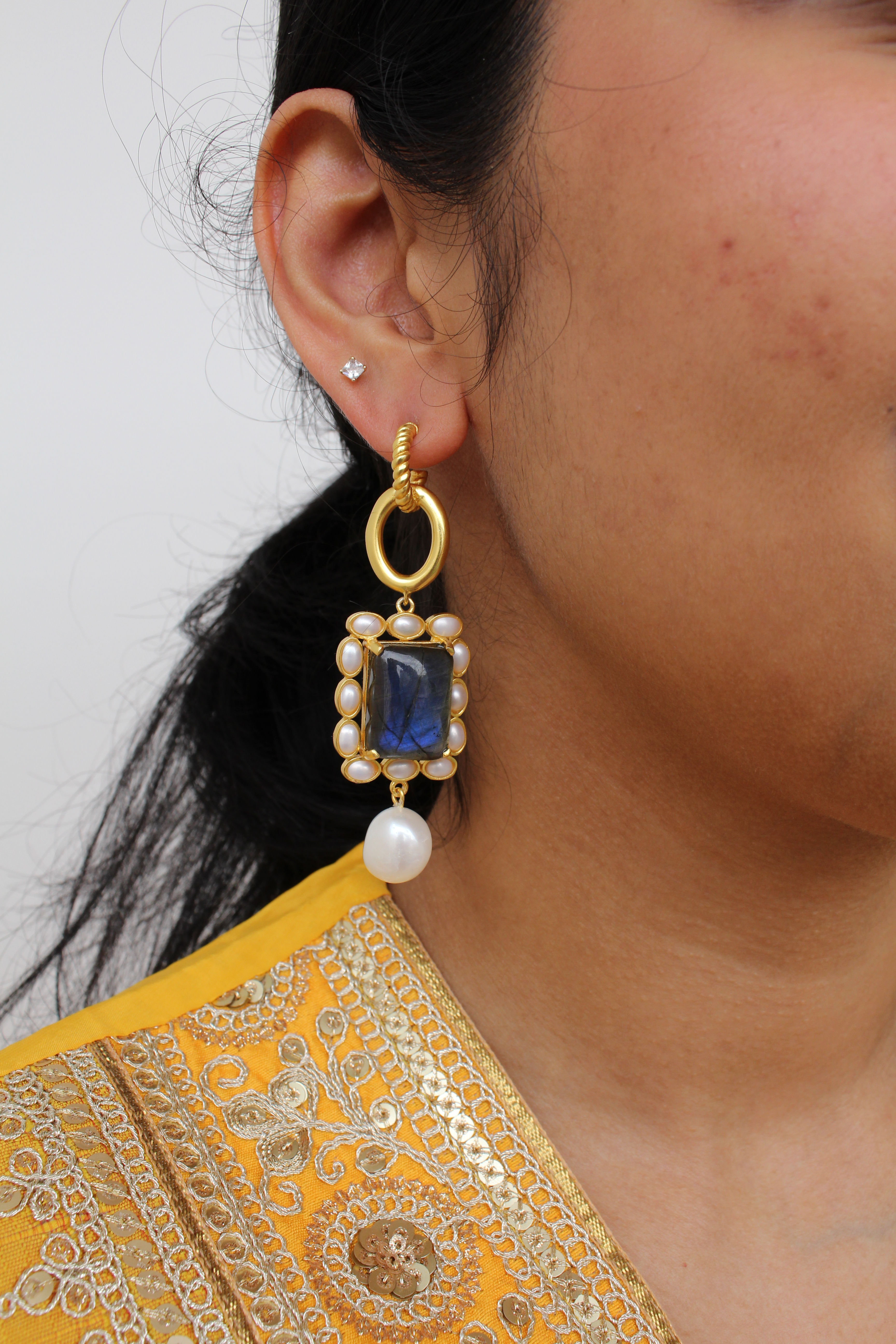 Elegant earring featuring a shimmering blue-grey labradorite stud, accented with tiny real pearls and a dangling, uniquely shaped baroque pearl