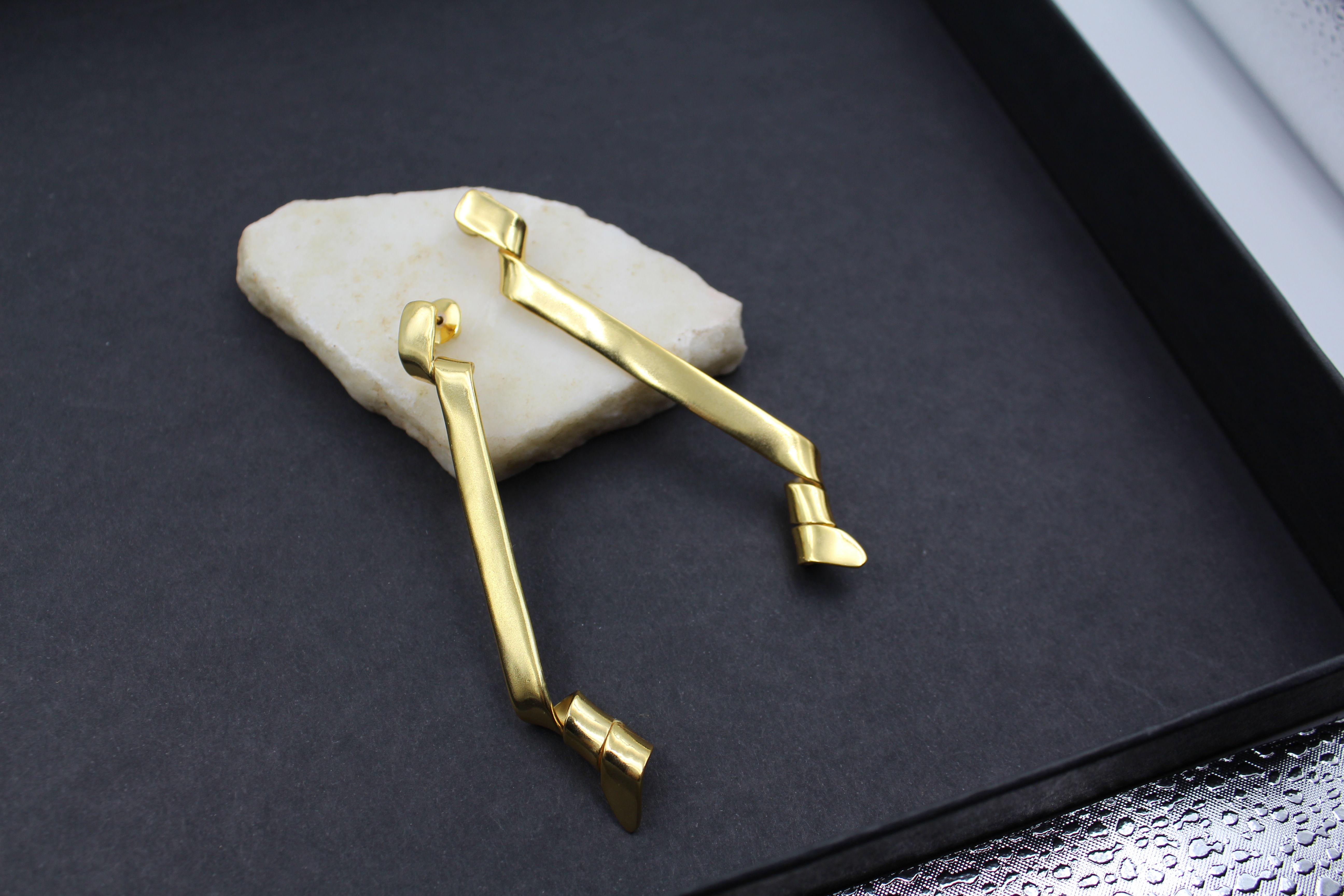 Minimalist ballet-inspired earrings featuring delicate, ribbon-like curves — elegant, dainty jewelry evoking ballerina grace and lightweight movement, perfect for everyday chic or feminine fashion trends