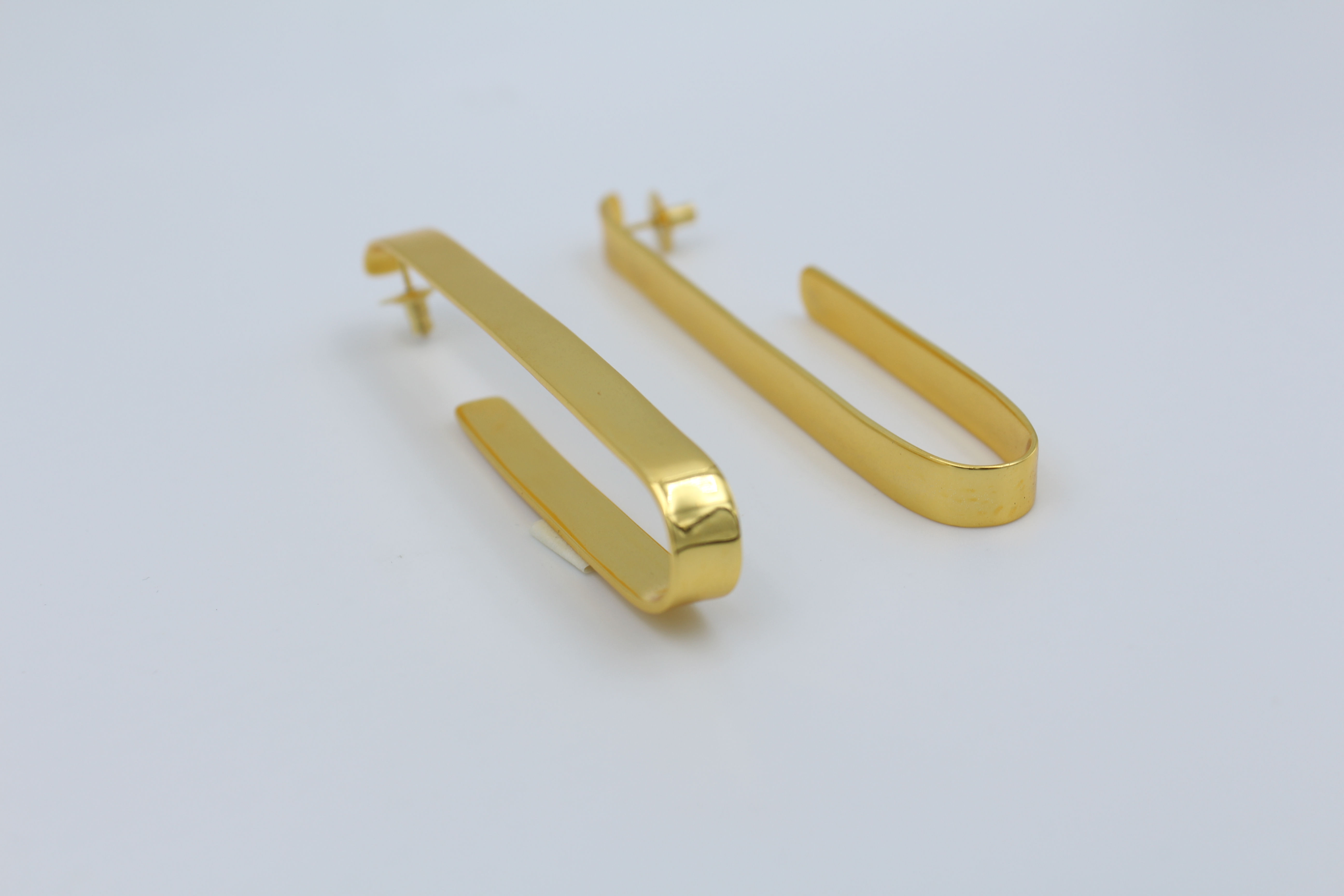 Minimalist ballet-inspired earrings featuring delicate, ribbon-like curves — elegant, dainty jewelry evoking ballerina grace and lightweight movement, perfect for everyday chic or feminine fashion trends