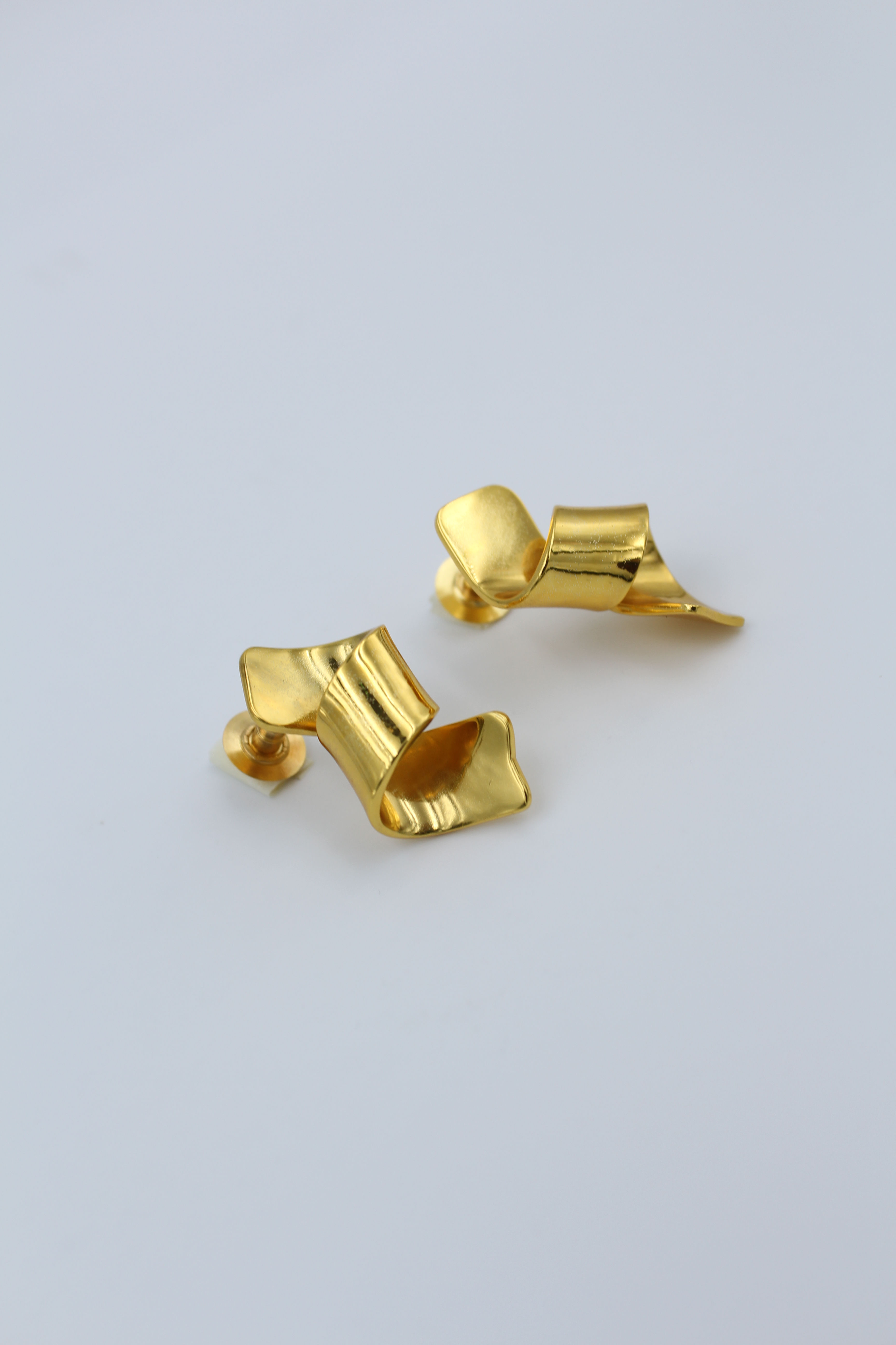 Minimalist ballet-inspired earrings featuring delicate, ribbon-like curves — elegant, dainty jewelry evoking ballerina grace and lightweight movement, perfect for everyday chic or feminine fashion trends
