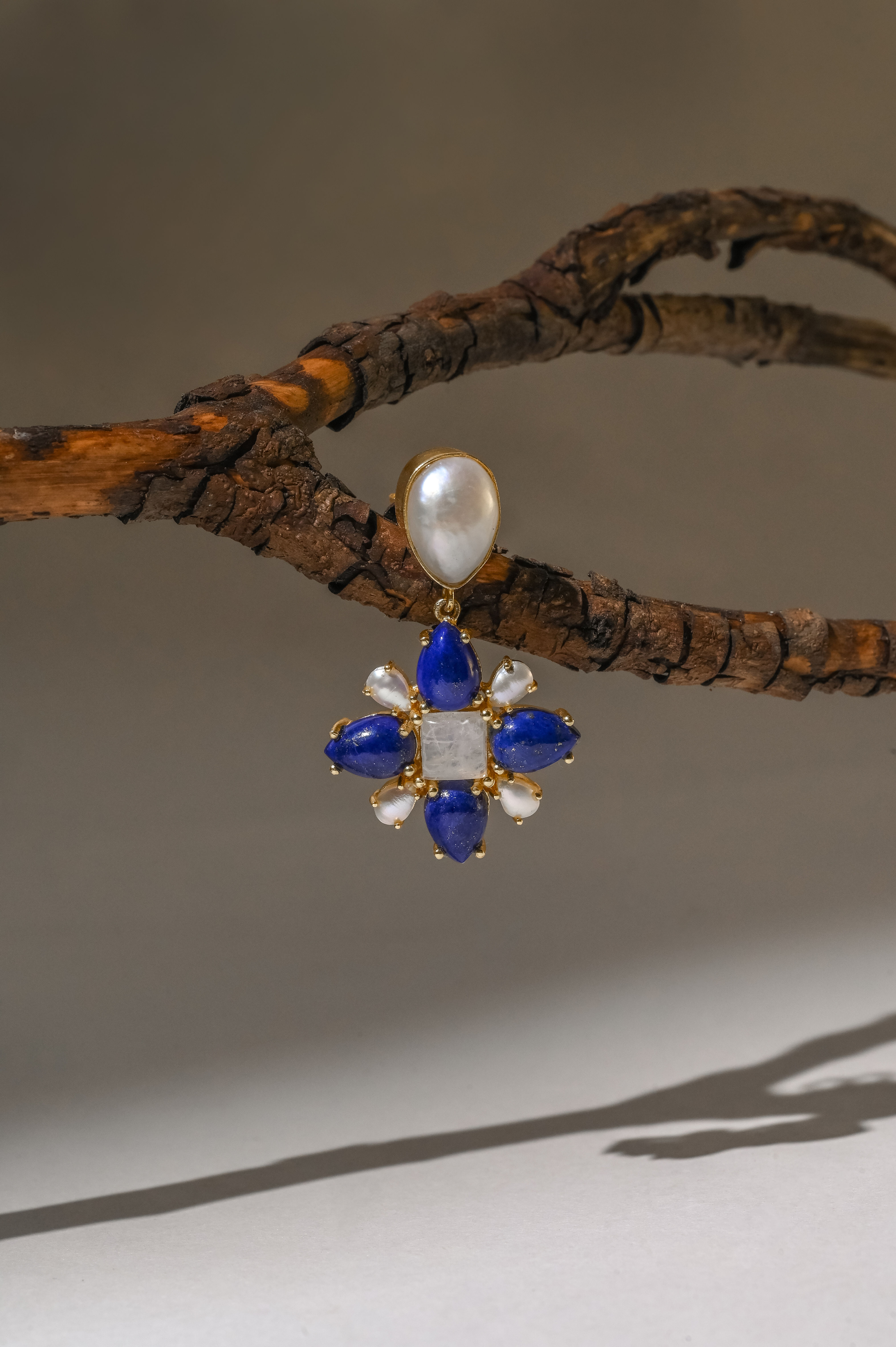 Elegant earrings featuring a vibrant real lapis stone, accented with tiny pearls and a radiant rainbow moonstone for a stunning, multi-dimensional look
