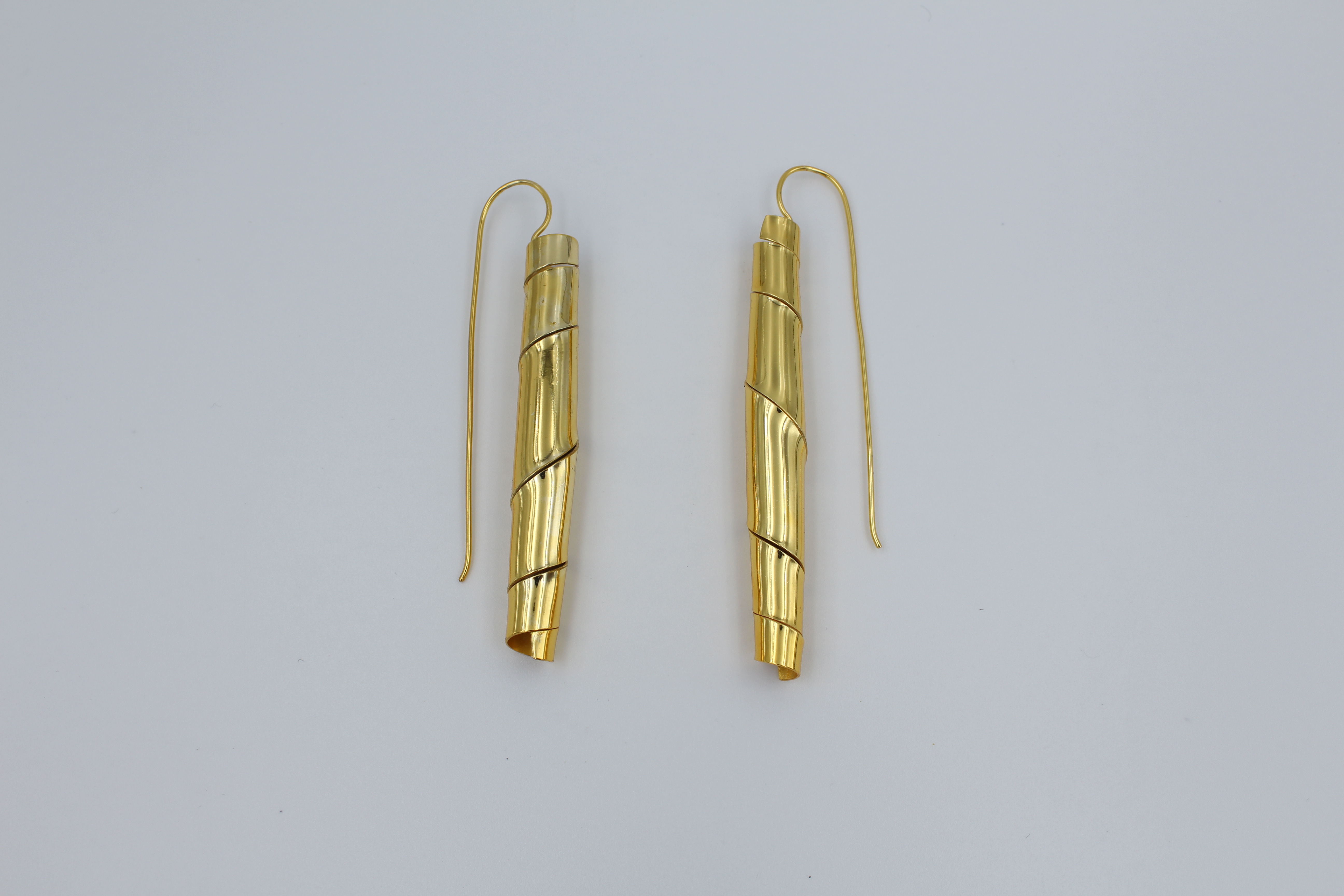 Minimalist ballet-inspired earrings featuring delicate, ribbon-like curves — elegant, dainty jewelry evoking ballerina grace and lightweight movement, perfect for everyday chic or feminine fashion trends