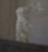 Classic headless Greek statue with outstretched wing covered in a glitter overlay.