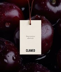 Hangtag mockup for Clawed Hair Studio over image of dark cherries.