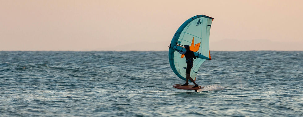 Wingfoiler having fun at sunset