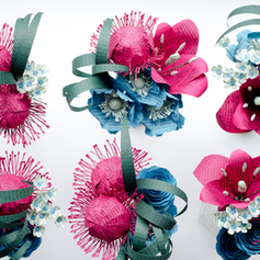 Arrangement of colorful paper flowers for a book themed wedding, pink and teal protea and anemones