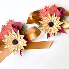 Fall color palette wedding theme - mother's wrist corsages made from book pages with ribbon ties