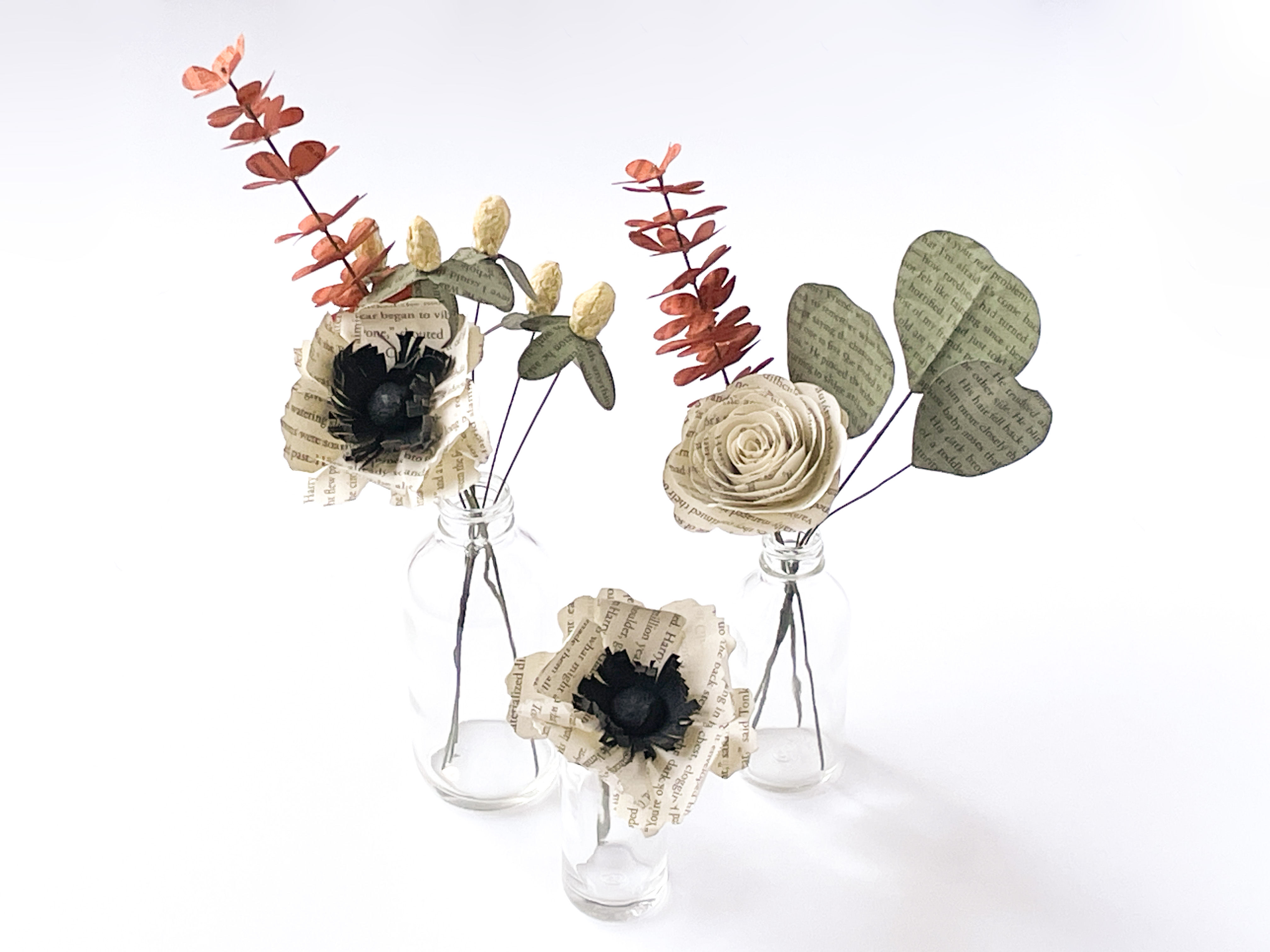 book page flowers in ivory, orange, yellow and green with three bud vases