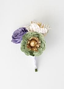 groom's boutonniere made from the pages of To Kill A Mockingbird with poppy, rose and lily