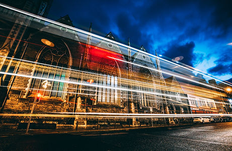 light-streaks-at-night-past-stone-church