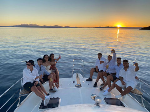 Friends enjoying sunset cruise on Kakariki Catamaran