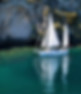 Sailboat cruising close to the Māori Rock Carvings at Mine Bay on Lake Taupō, offering a peaceful and eco-friendly cultural tour experience.