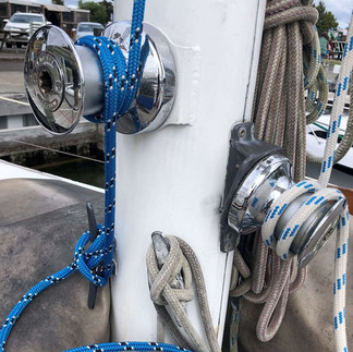 Close-up of sailing boat winches and ropes, highlighting moving parts that passengers should avoid for safety while on board.