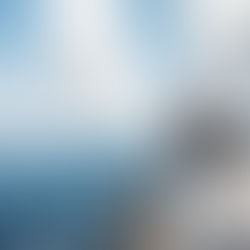 People relaxing on the deck of an electric yacht sailing on Lake Taupō, with clear blue water and open sky.