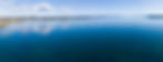 Aerial view of Lake Taupō, New Zealand’s volcanic caldera, with clear blue waters and distant shoreline