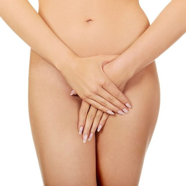 woman covering intimate areas on body